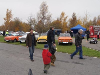 Návštěvníci na pozadí historické automobily